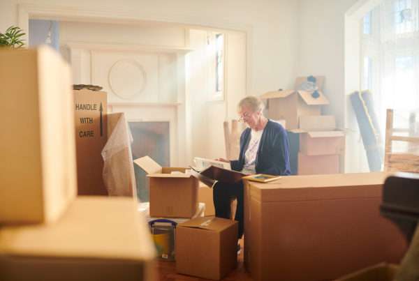 women at home with moving boxes